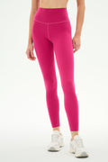 A person is wearing SPLITS59 Airweight High Waist Legging in Sangria, crafted from ultra-soft Airweight fabric, paired with white sneakers and standing against a plain white background—an ideal outfit for hot yoga or everyday comfort.