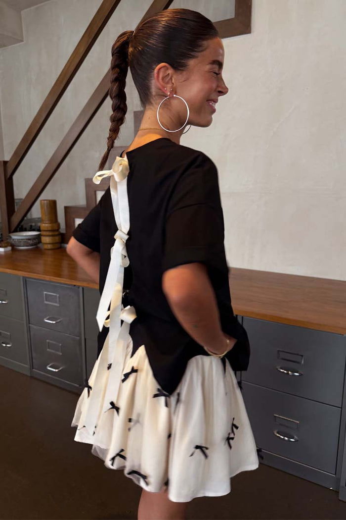 Black Bow Mini Monika Skirt in white pleated tulle mesh with tiny black bow embellishments.