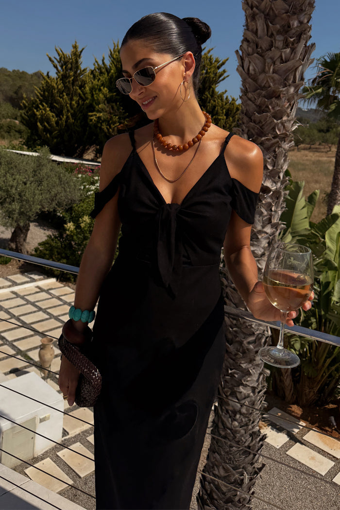 Black Cassie Dress featuring a tie-front bust and off-the-shoulder sleeves in a linen blend.