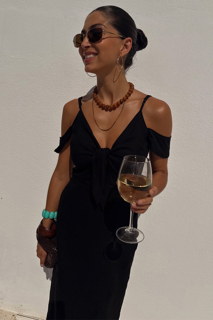 Multi-wear Black Cassie Dress in a linen blend with off-the-shoulder sleeves and tie front for vacation.