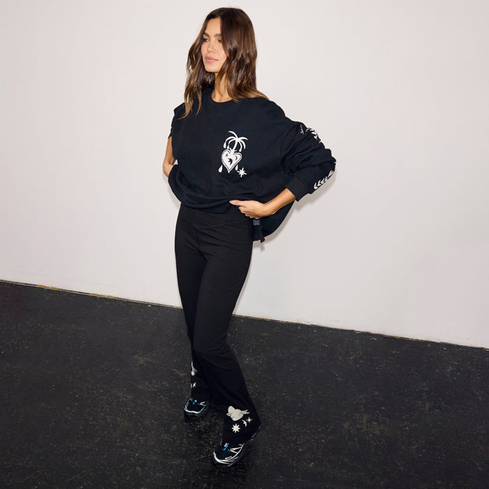 Black Cotton Wide Leg flares featuring ecru embroidered motifs, paired with a matching sweatshirt for a casual co-ord.