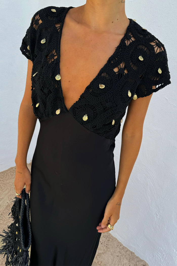 Black Crochet Shell Elodie Dress with gold shell charms on the crochet bodice and a black satin skirt.