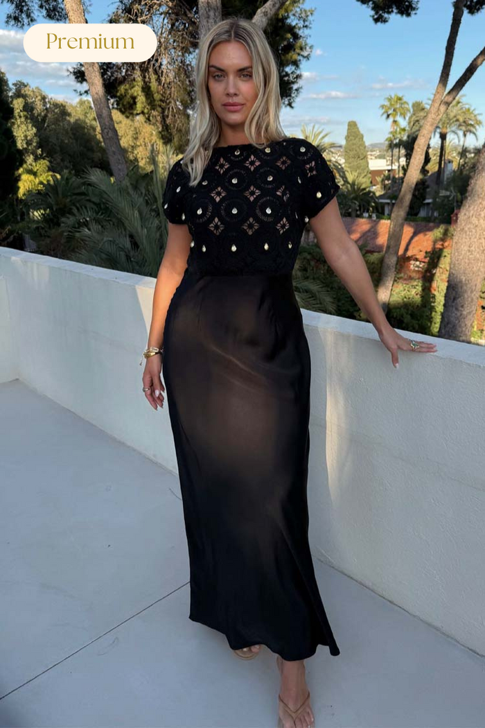 Black Crochet Shell Elodie Dress with gold shell embellishments on a crochet top and a satin midaxi skirt.