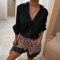 Black Miley Shirt with blouson sleeves and tortoise buttons paired with leopard print lace trim shorts.