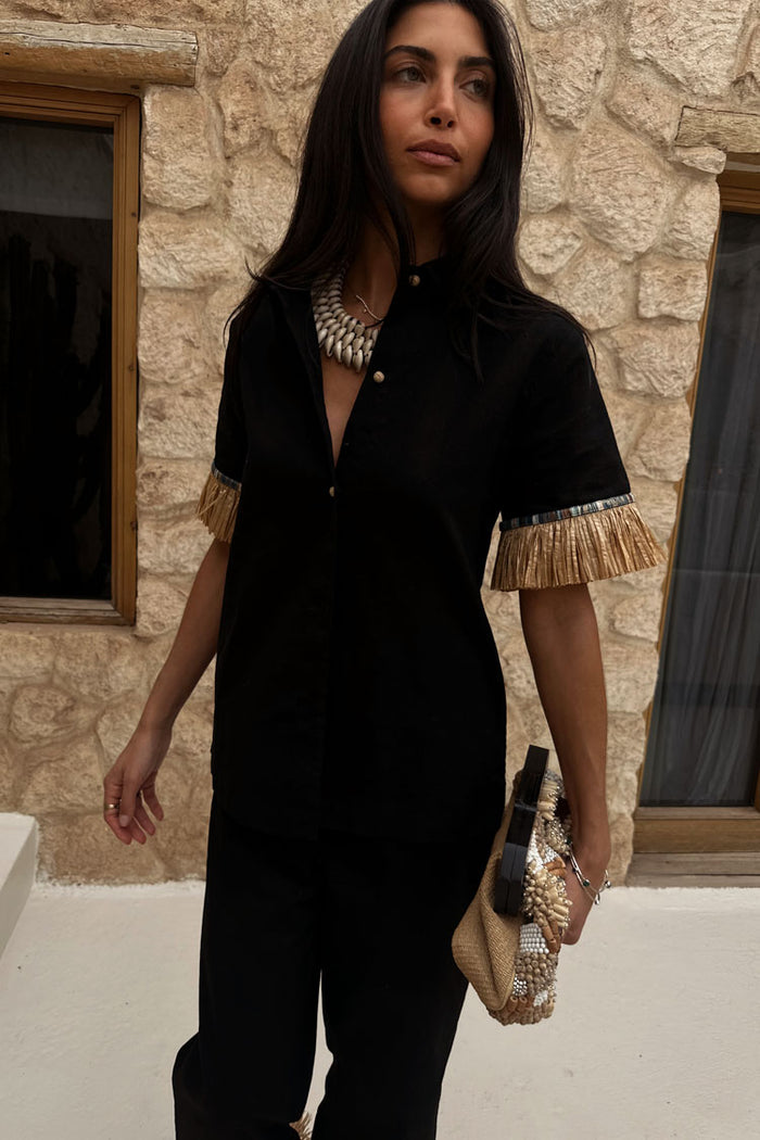 Black Raffia Shirt with fringed sleeve trims and shell buttons, styled with a shell necklace and raffia clutch.