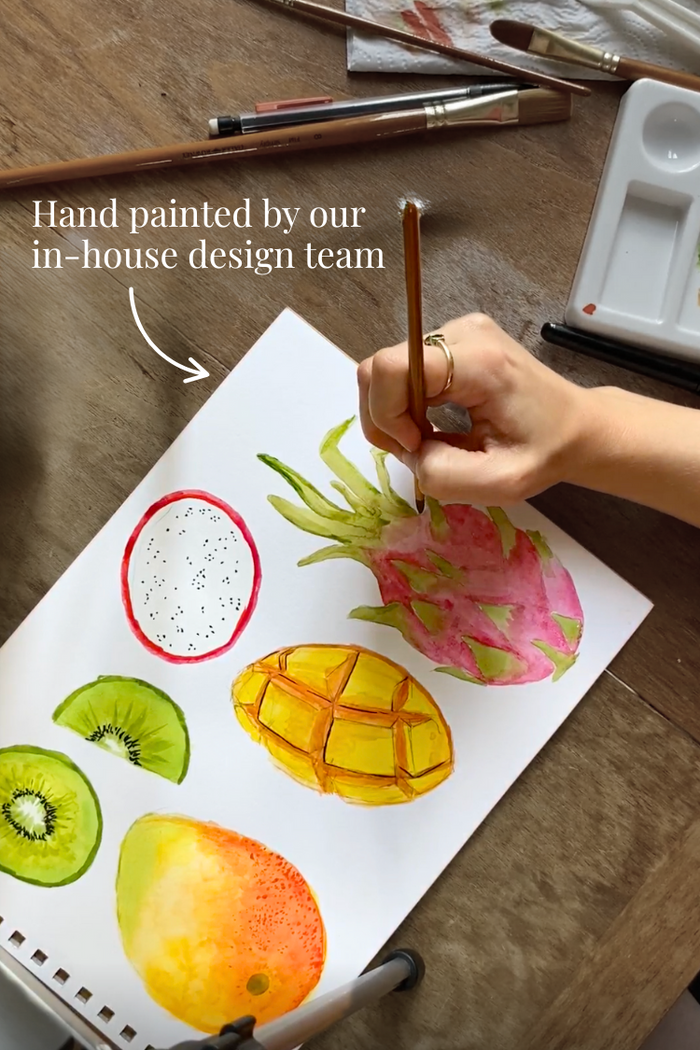 Hand-painted tropical fruits like dragon fruit and mango, designed in-house for the Rio print.
