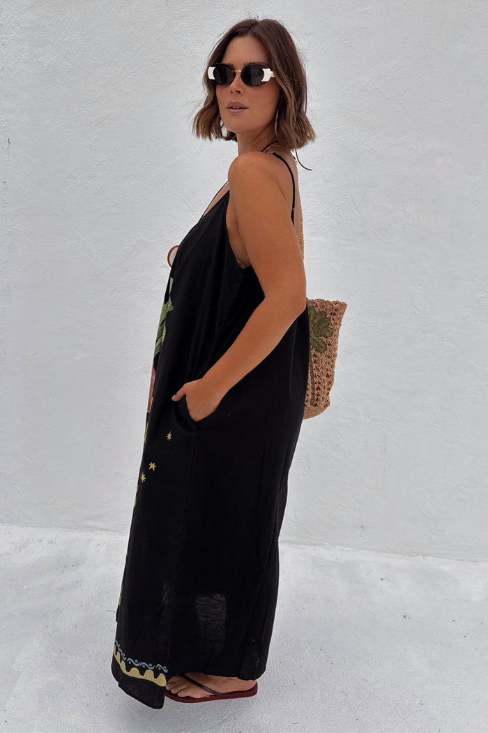 Black Rio Maxi Dress with hand-painted tropical motifs and side pockets, designed in-house for inclusive sizing.