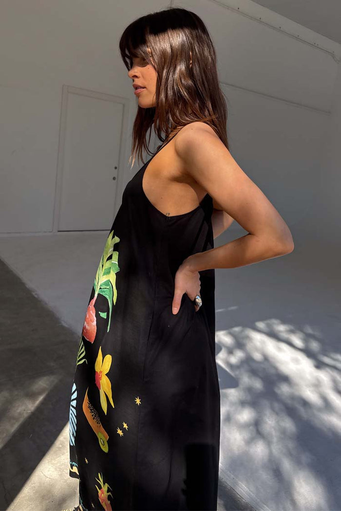 Black Rio Maxi Dress featuring colourful hand-painted tropical fruit motifs and thin adjustable straps.