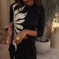 Black Sol Alexa Cardigan featuring a large cream sun print, ribbed texture, and button-up fastening.