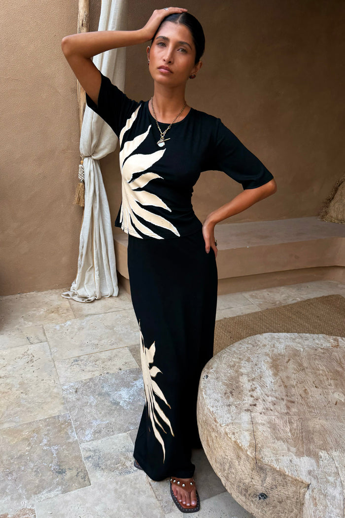 NFD Black Sol Rib T-Shirt with a cream hand-painted sun print, styled as a co-ord with a matching skirt.