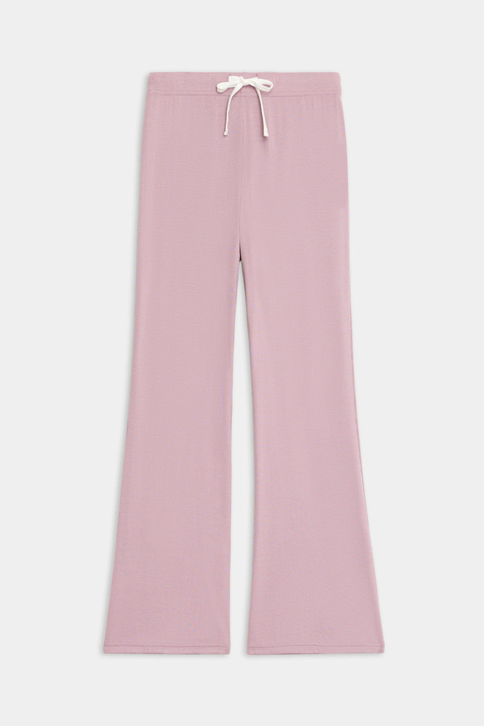 The SPLITS59 Blaire Rib Pant features a light pink, wide-leg knit design with an elastic waistband and white drawstring, shown laid flat on a plain white background.