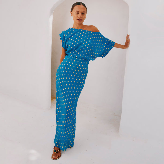 NFD Blue Jacquard Tilly Dress with gold flecked dots and an off-the-shoulder silhouette, styled for a vacation.