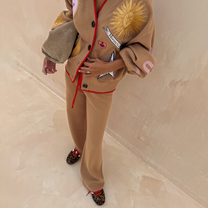 Camel Wide Leg Joggers with red trim and drawstring, paired with a sun-embroidered cardigan and leopard trainers.