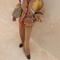 Camel Wide Leg Joggers with red trim and drawstring, paired with a sun-embroidered cardigan and leopard trainers.
