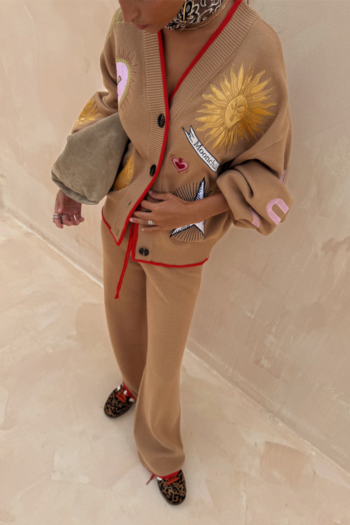 Knitted Camel Wide Leg Joggers with red trim, styled with the matching Mystical Cardigan and leopard print shoes.
