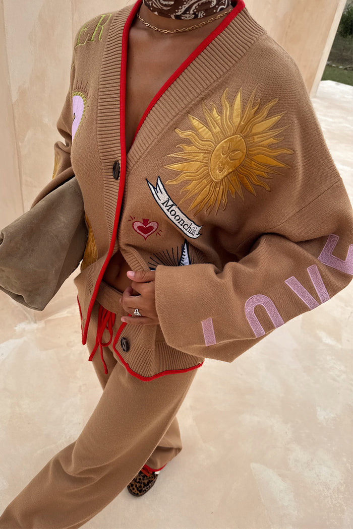 Camel Wide Leg Joggers and matching sun embroidered Mystical Cardigan with red trim on a 5ft4” model, waistband folded.