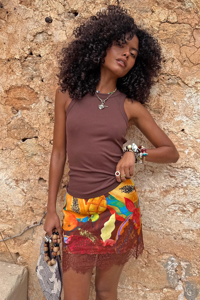 Chocolate Ribbed Tank in soft stretch fabric, styled with a vibrant fruit print lace skirt for a summer vacation look.