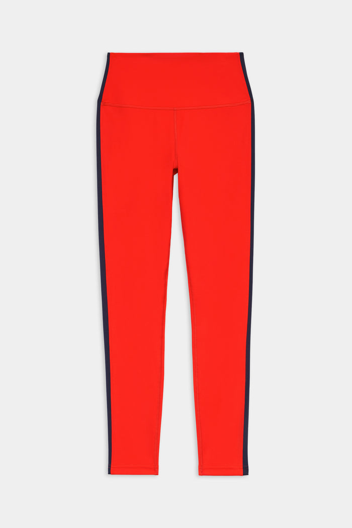 The SPLITS59 Clare High Waist Rigor 7/8 in Lotus Red/Indigo features bold navy side panels, designed for performance and ideal for gym workouts, shown flat on a white background.