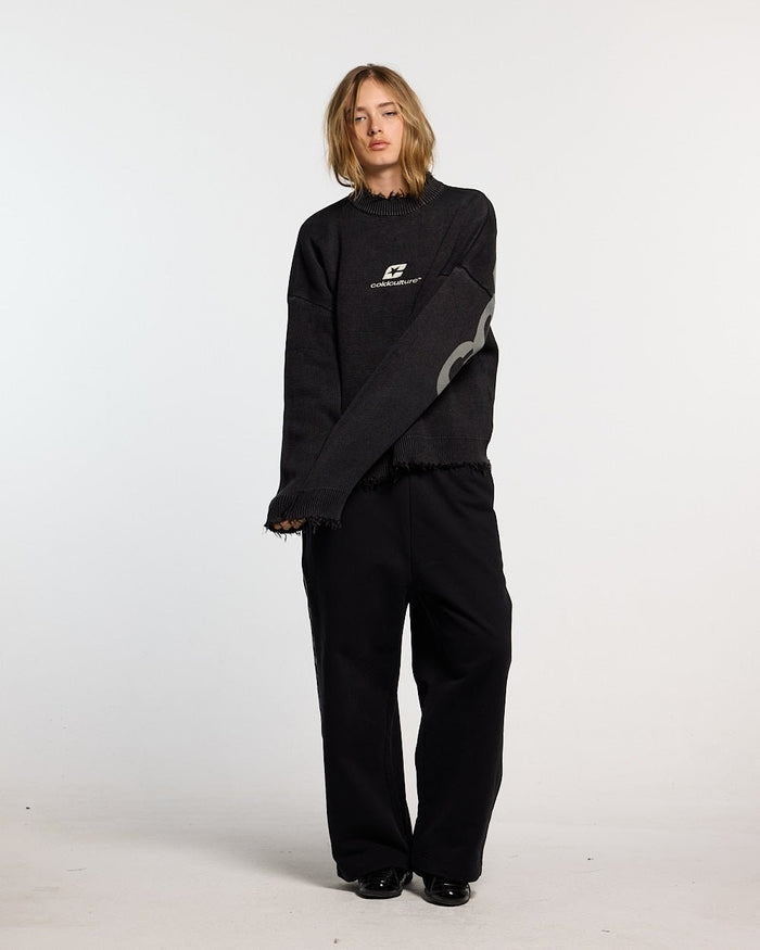 COZY CURVED KNITWEAR BLACK - black distressed knit sweater, front view on female model - Cold Culture #woman