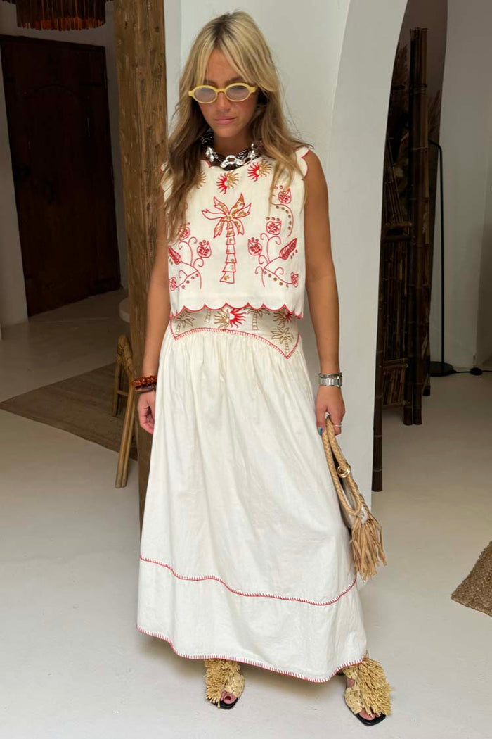 Cream Pollenca cotton skirt co-ord with red embroidered palm trees and contrast blanket stitching.