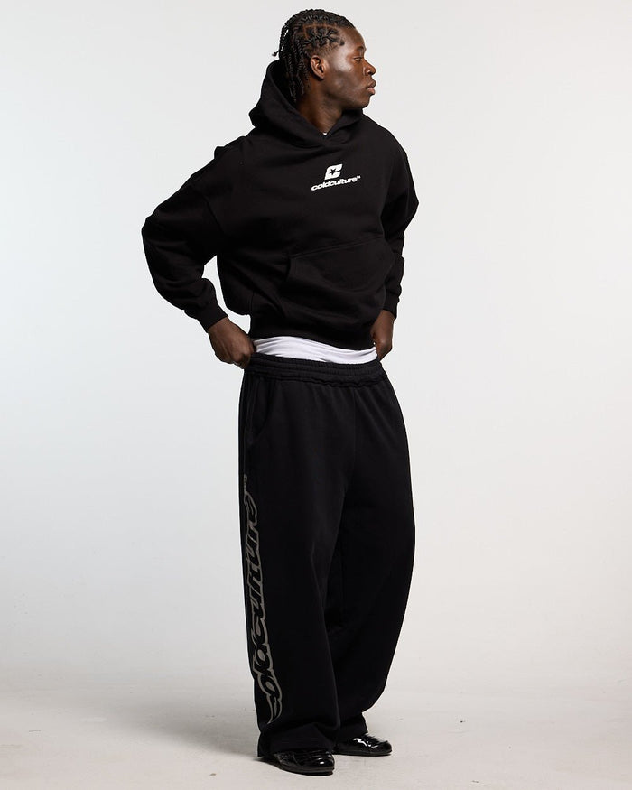 CURVED HOODIE BLACK AND WHITE - black oversized hoodie, front view on male model - Cold Culture #man