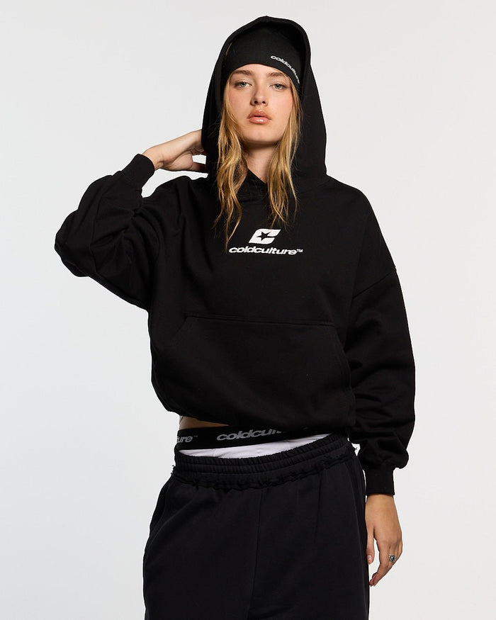 CURVED HOODIE BLACK AND WHITE - black oversized hoodie, front view on female model - Cold Culture #woman