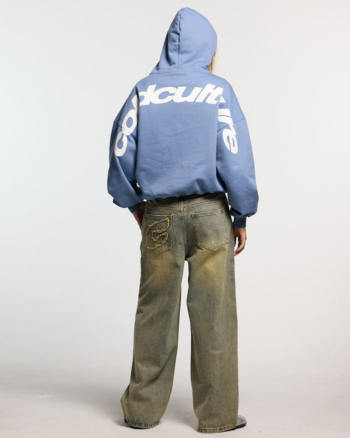 CURVED HOODIE LIGHT BLUE - light blue oversized hoodie, back view on female model - Cold Culture #woman