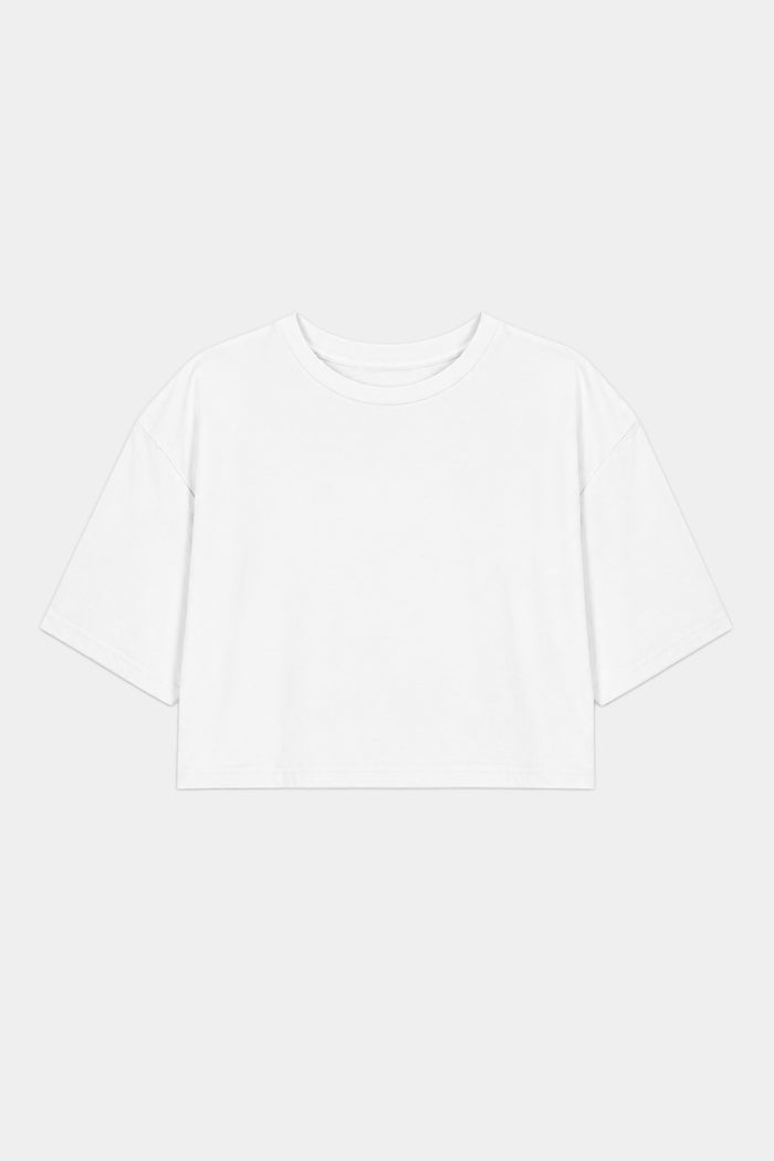 The SPLITS59 Djuna Oversized Crop Jersey Tee in white, a short-sleeve, cropped t-shirt made from a soft spandex blend, is laid flat on a light gray background.