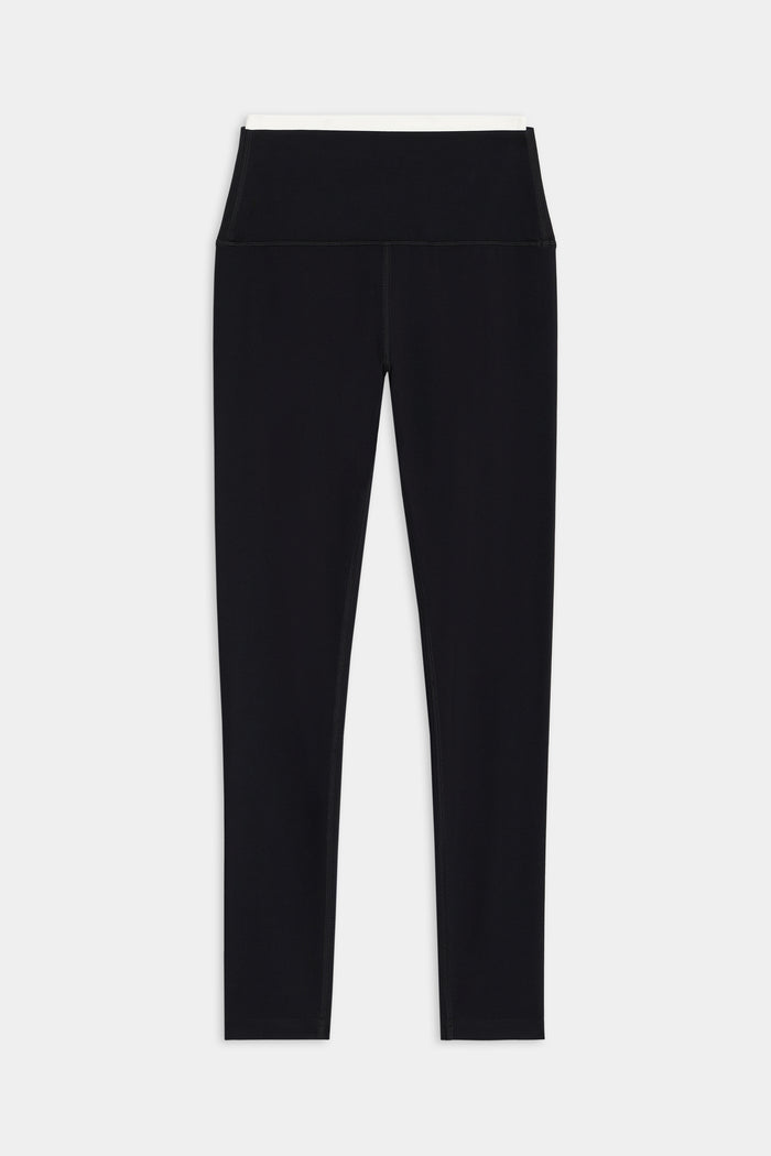 The SPLITS59 Dual High Waist Airweight 7/8 leggings in Black/White feature a wide waistband and ultra luxe fabric, shown laid flat on a white background.