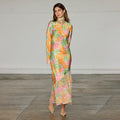 Floral Alaia Dress featuring a multicoloured floral print with gold flecks, long sleeves and an asymmetric skirt.