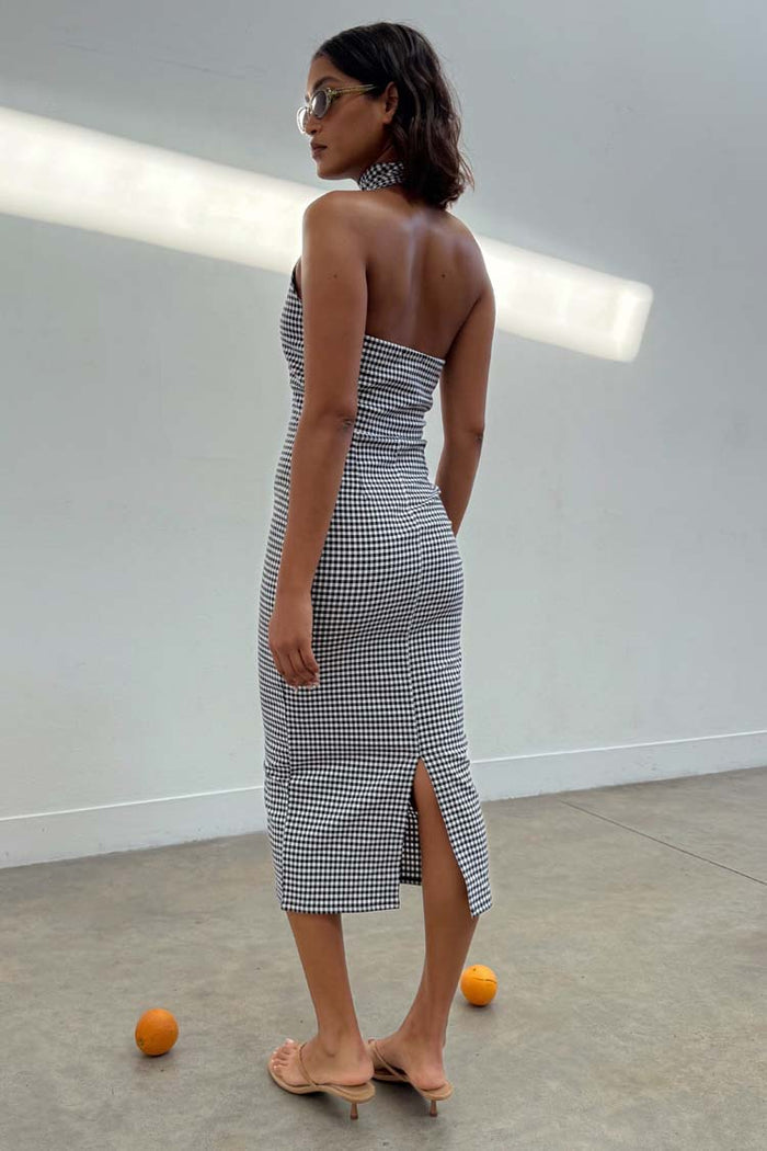 Black and white Gingham Halterneck Midi Dress featuring a back slit, styled with sunglasses and heels.