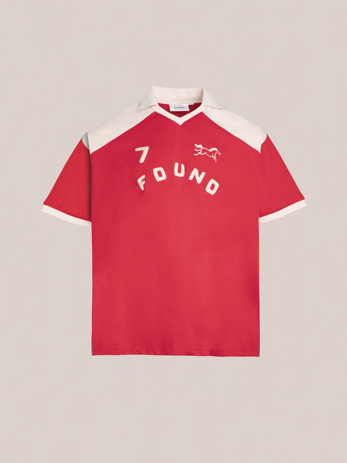 Introducing the Goji Red Jersey by FOUND, showcasing white contrast color yoke and collar, featuring the number 7. This stylish piece includes a small horse graphic and the brand name "FOUND" in vintage athletic uniform style on the front.
