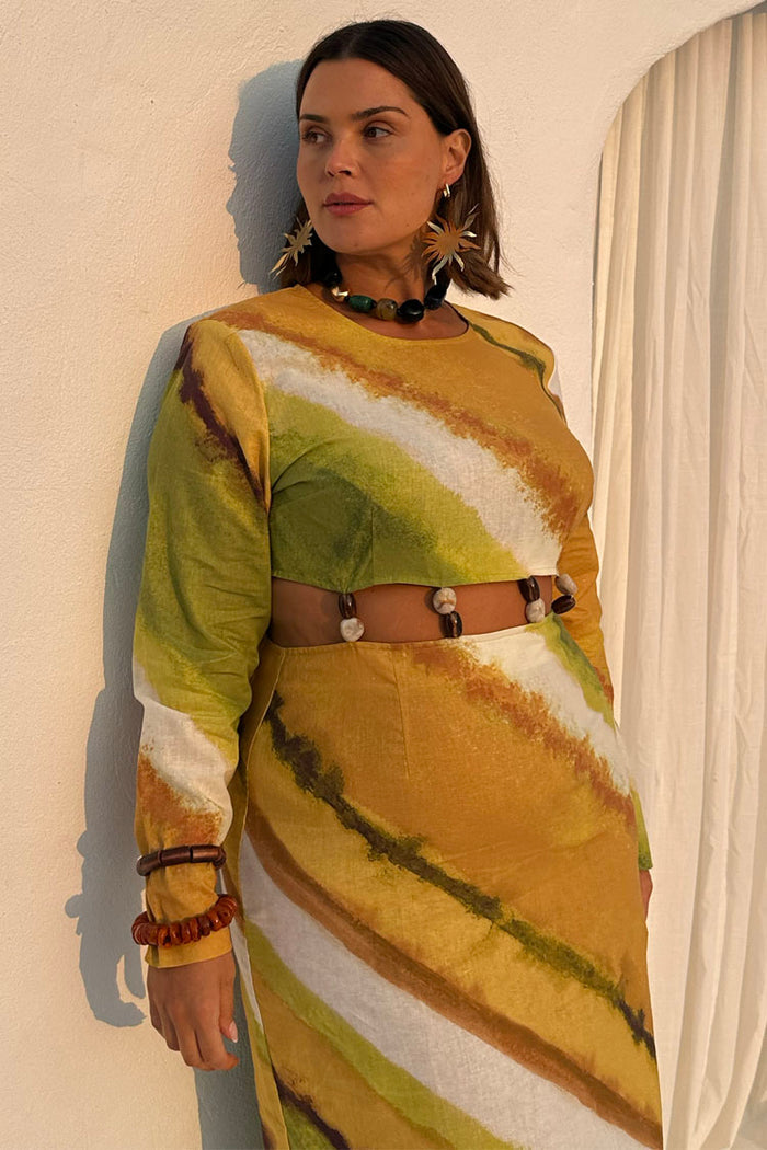 Green Ombre Alba Dress in earthy tones, featuring a waist cut-out with stone beads on a model in UK size 18.