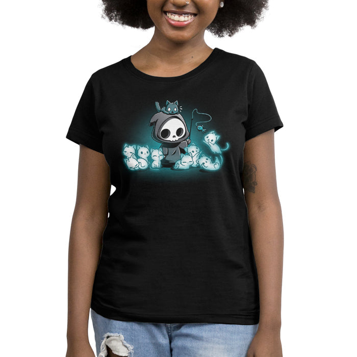 Women's Premium T-Shirt_TeeTurtle Grim and Kitties black t-shirt featuring a hooded skeleton figure, resembling a spooky Grim Reaper, standing surrounded by glowing ghostly cats. One cat is perched on its head while it playfully dangles a toy fish in front of the others.