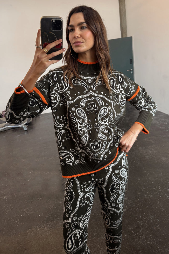 Khaki Bandana Dana Jumper with white print and orange contrast hems, styled as a knit co-ord in a mirror selfie.