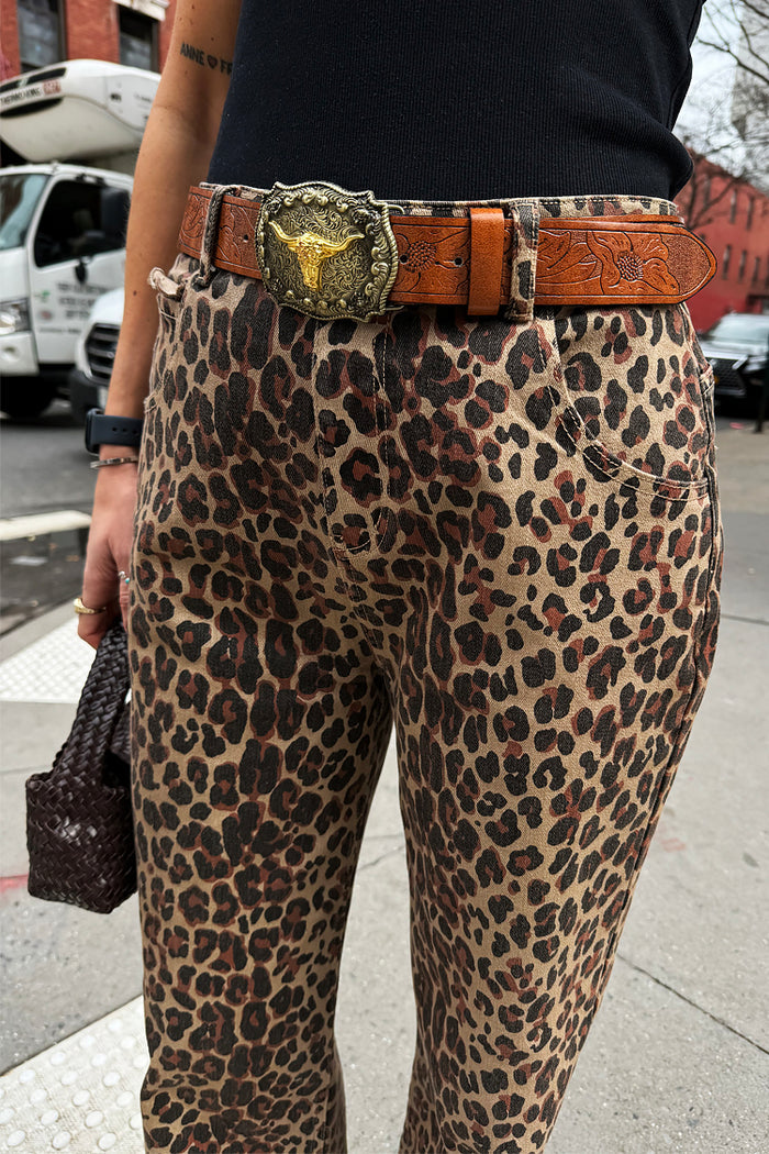 Leopard Lucia jeans featuring scalloped pocket details and a western bull buckle belt in a street style setting.