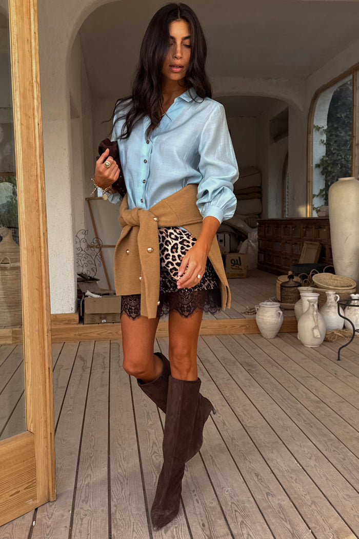 Leopard Lace Mini Maeva Skirt with a black lace hem, styled with a blue shirt and brown knee-high boots.