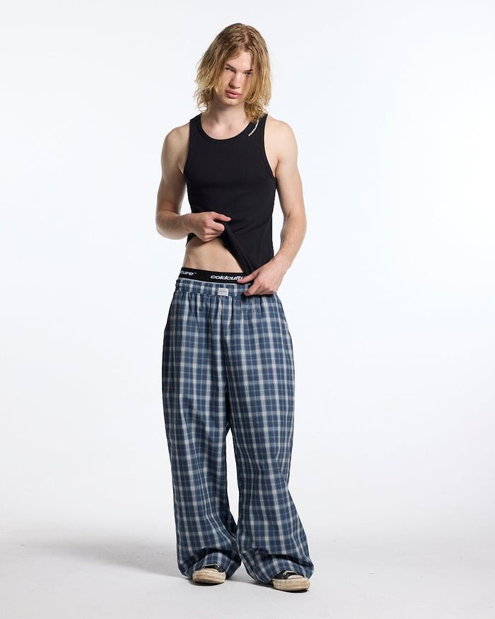 LIAR PANTS BLUE - blue plaid women's sweatpants, front view on male model - Cold Culture #man