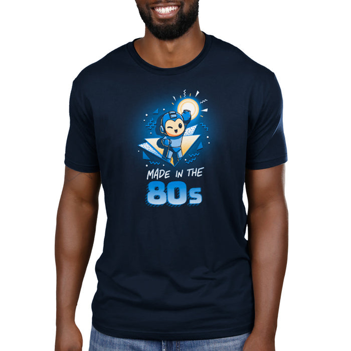 Premium Cotton T-shirt_TeeTurtle navy blue Made in the 80s featuring a winking Mega Man with his blaster arm in the air surrounded by 80s graphic elements, and the caption, "Made in the 80s".