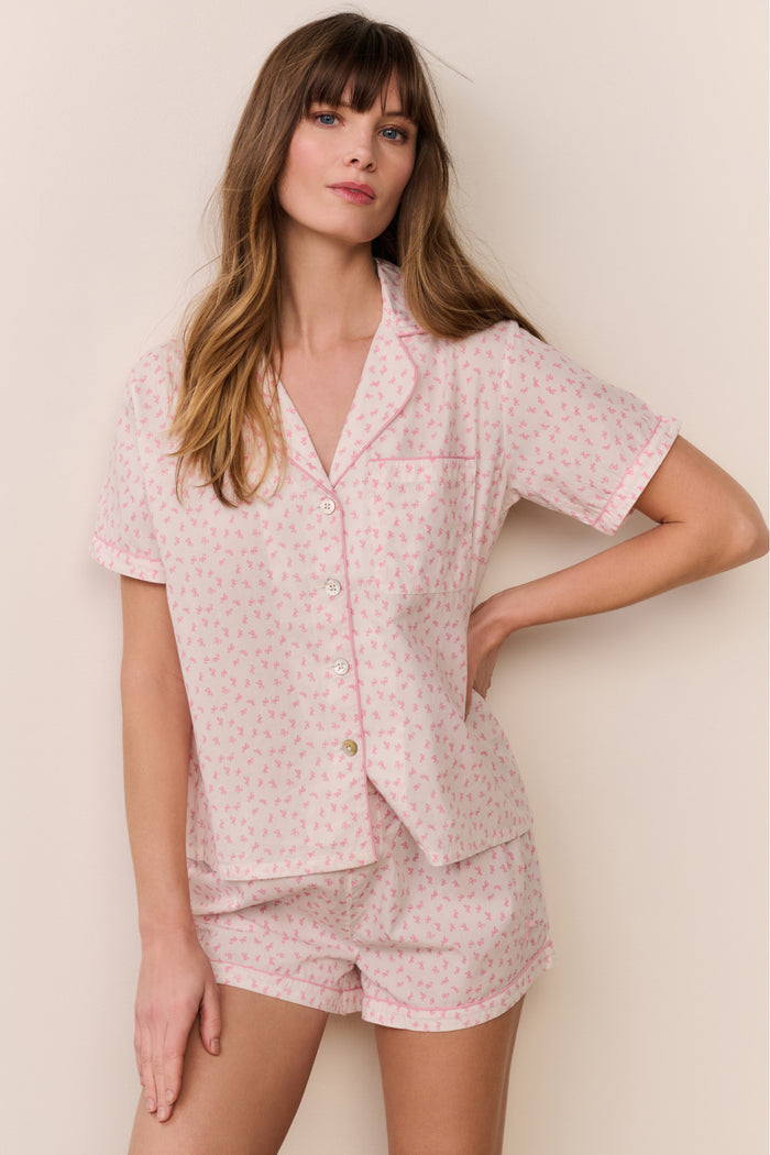 Woman wearing a pink pajama set with white background