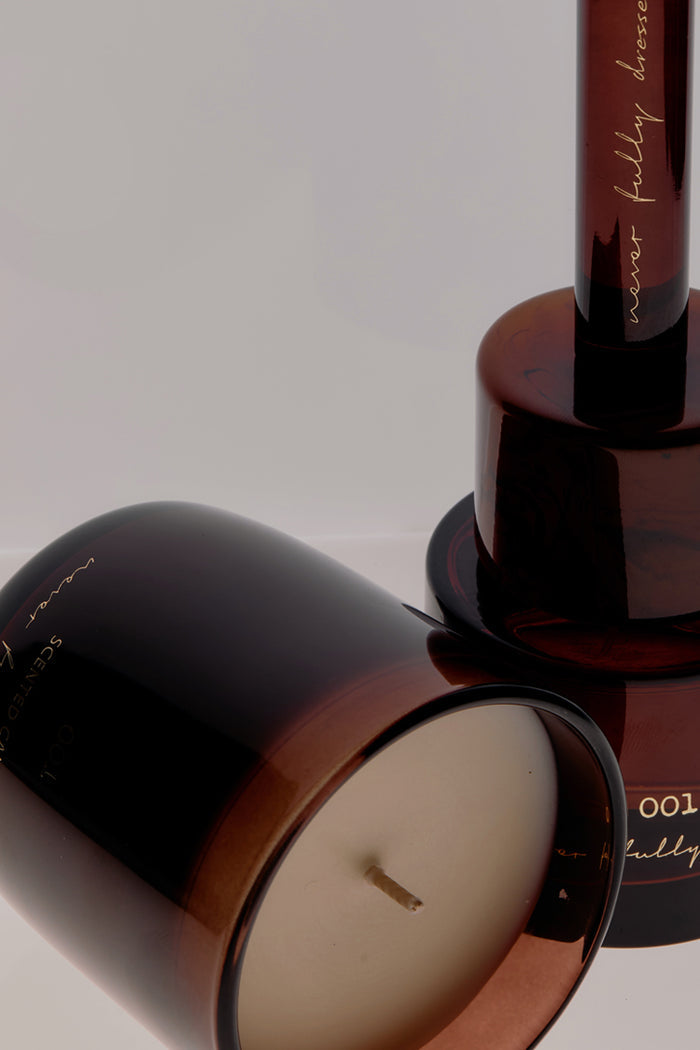 Amber glass NFD Eau De Parfum Candle 001 featuring gold script branding and a visible wick.