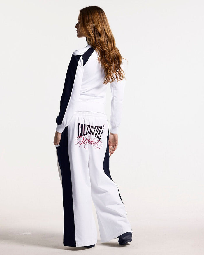 NIA SET ZIP UP WHITE & BLACK - white and black zip-up hoodie, back view on female model - Cold Culture #woman