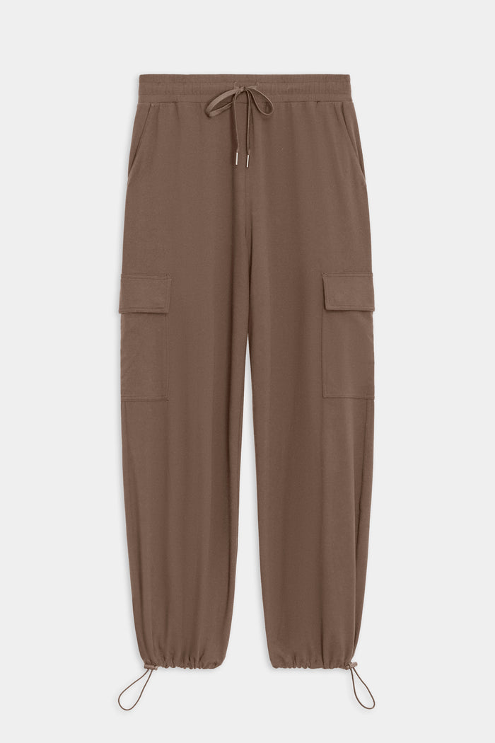 The SPLITS59 Nico Airweight Cargo Pant in Lentil offers lightweight comfort with an elastic waistband, drawstring tie, side pockets, thigh flap pockets, and adjustable ankle drawcords—perfect for workouts or casual wear. Shown flat on a white background.