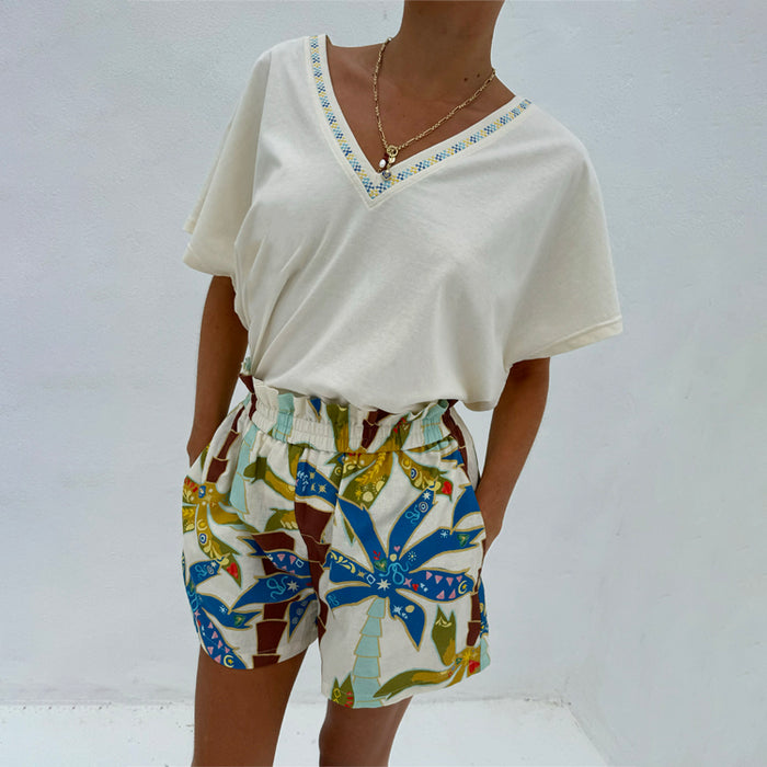 Multi-coloured Palm Elissa Shorts in cotton-linen featuring a palm leaf print and elasticated waist, styled with a cream tee.