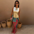 Pastel Morocco Dorris Skirt with multi-coloured abstract prints and NFD motifs, styled with a metallic gold vest.