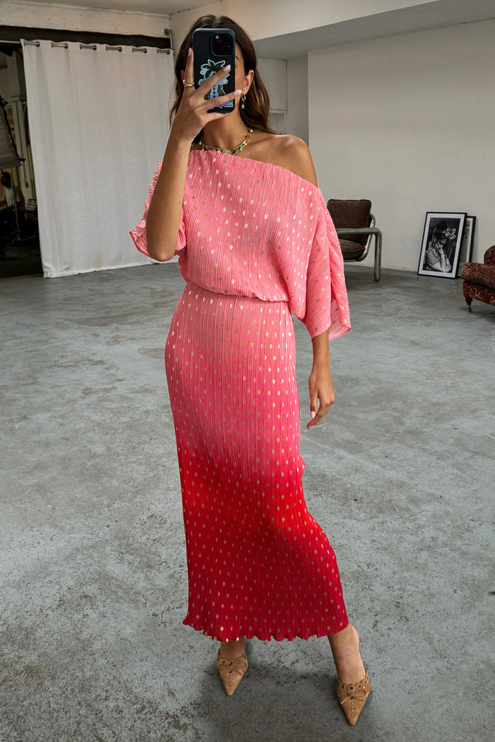 Pink and red ombre Tilly Dress in gold shimmer plisse, styled as a one-shoulder midi dress in a mirror selfie.