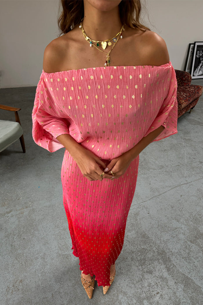 Pink and red ombre Tilly Dress in plisse with gold shimmer and an off-the-shoulder neckline on a model.