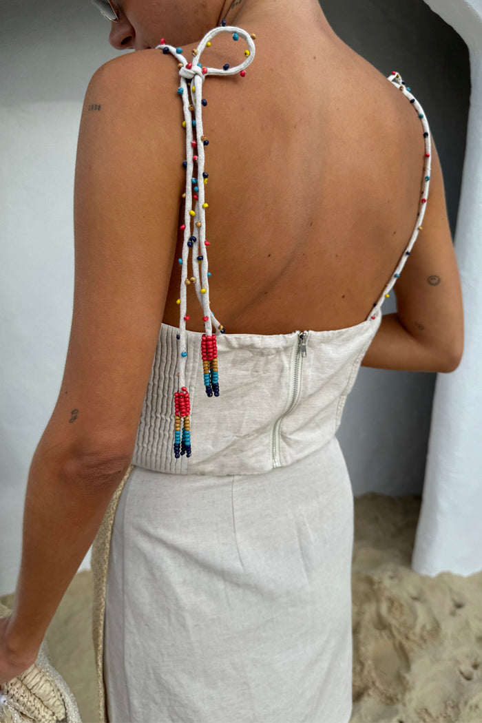 Beige Raffia Cecilia Top featuring multi-tie straps with multicoloured glass beads and a back zip closure.