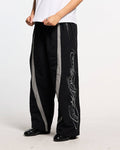 SCRIPT TECH PANTS BLACK - black script print sweatpants, front view on male model - Cold Culture #man