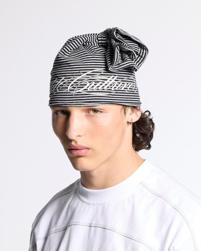 SCRIPTED STRIPES KNOT BEANIE BLACK - black striped knot beanie, front view on male model - Cold Culture